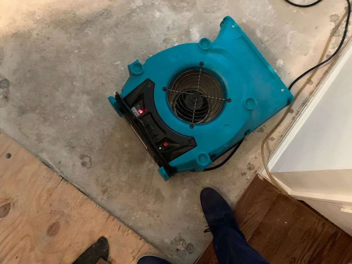 Air mover drying subfloor during Commercial Water Damage Restoration in Lantana